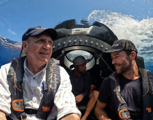 3 people sitting inside a submarine